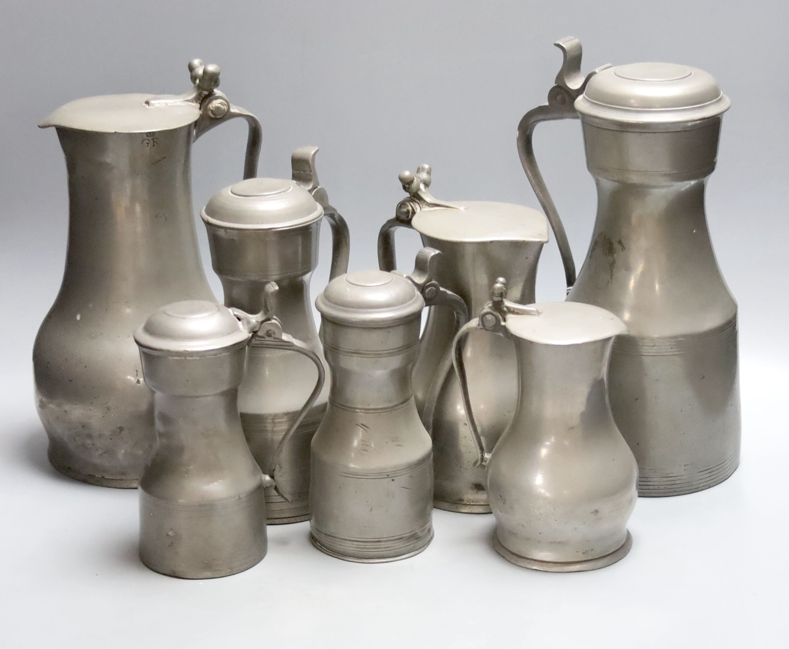 A graduated set of three Jersey pewter flagon measures, by John de St Croix, c.1730, tallest 27cm, and four pewter measures, c.1780, tallest 28cm (7)